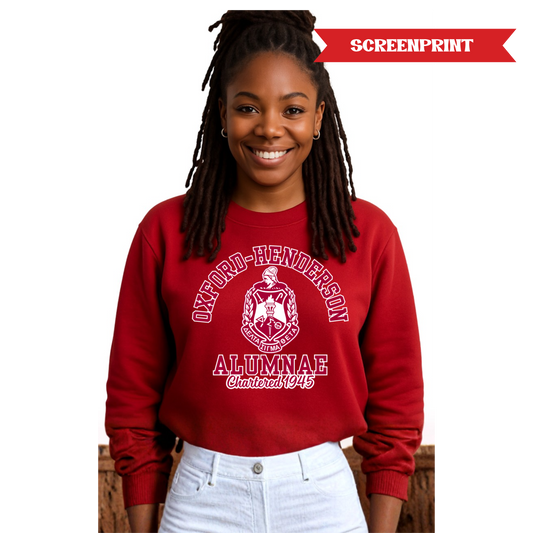 Person wearing a red sweatshirt with 'Oxford-Henderson Alumnae' print on a white background