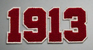 Patch with '1913' in red and white on a beige background