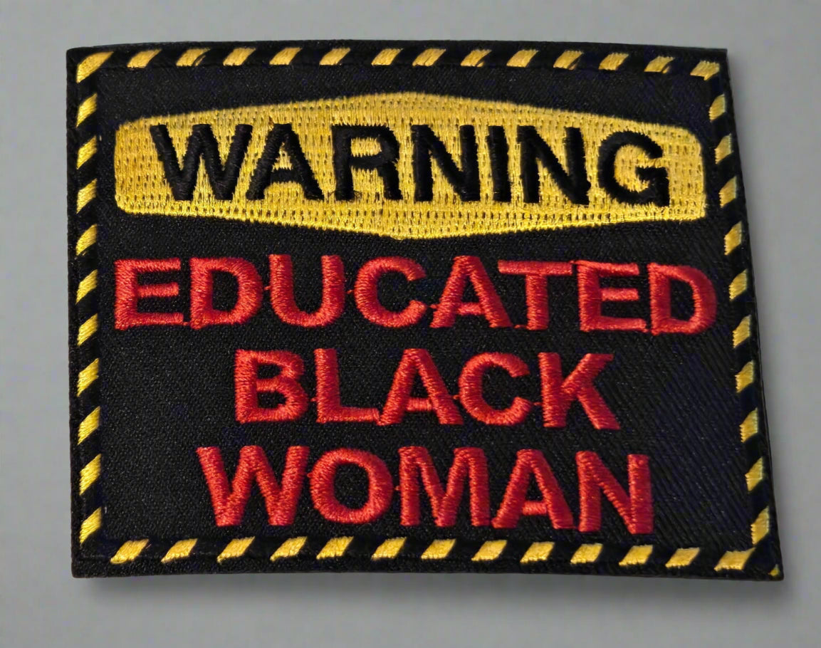 Patch with 'WARNING: EDUCATED BLACK WOMAN' text on a white background
