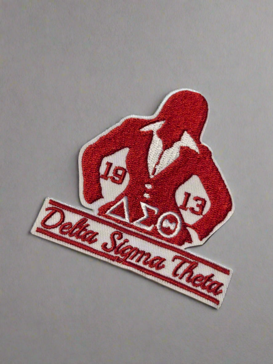 Red and white Delta Sigma Theta patch on a beige background