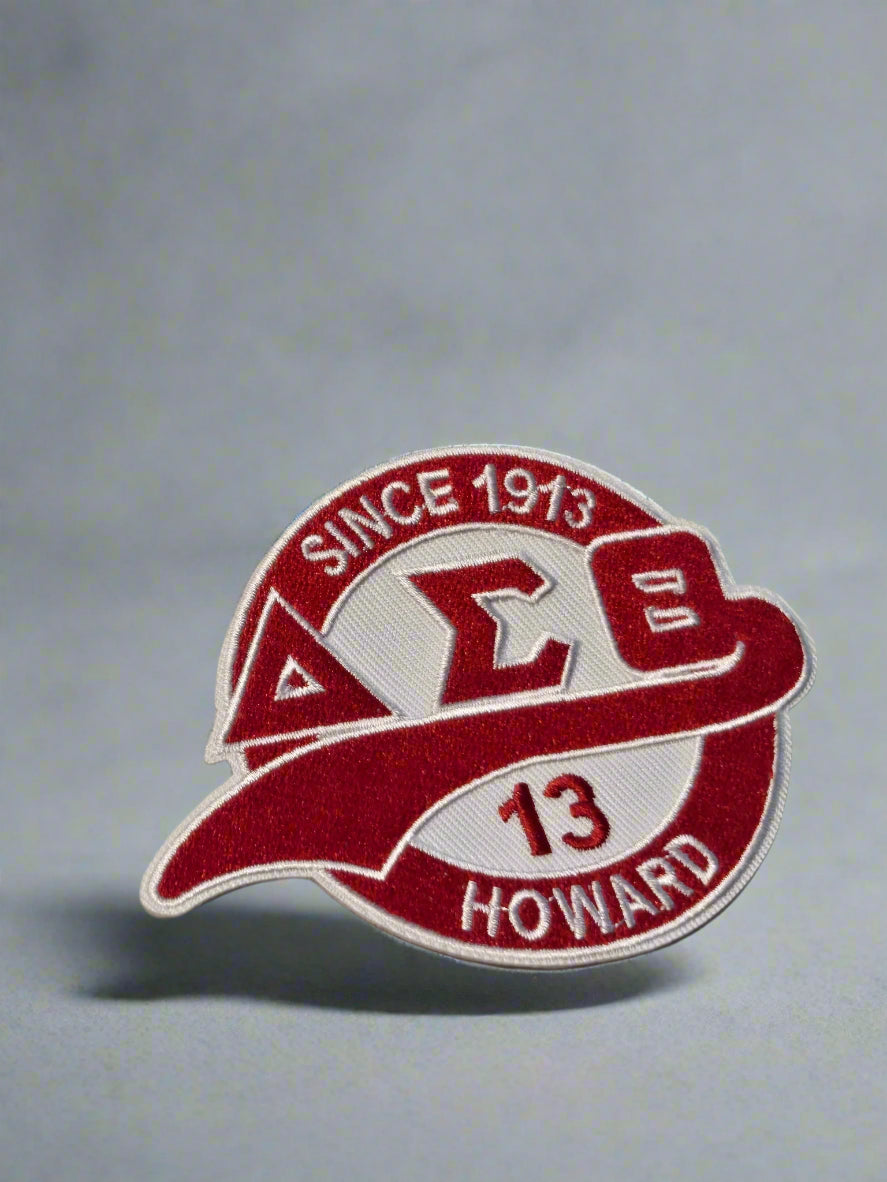 Red and white patch with 'Delta Sigma Beta' text on a light gray background