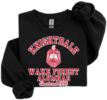 A collection of unisex sweatshirts in black, white and red colors, featuring the text 'Knightdale Wake Forest Alumnae' and the logo of Delta Sigma Theta Sorority, Inc.