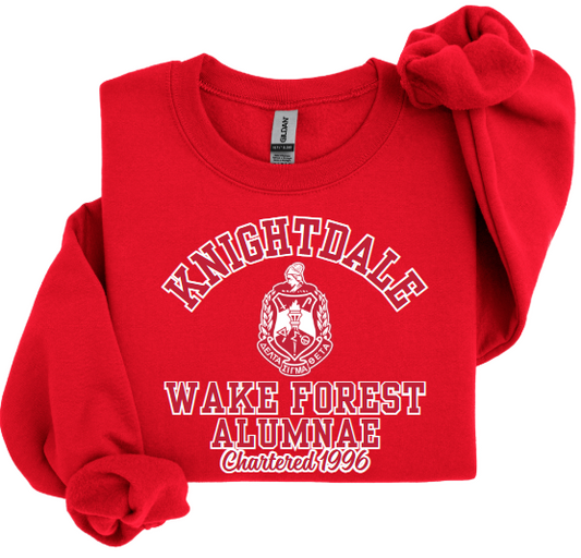 A red sweatshirt with 'KNIGHTDALE WAKE FOREST ALUMNAE' screenprint on the front.