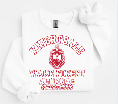 A collection of unisex sweatshirts in black, white,  and red colors, featuring the text 'Knightdale Wake Forest Alumnae' and the logo of Delta Sigma Theta Sorority, Inc.