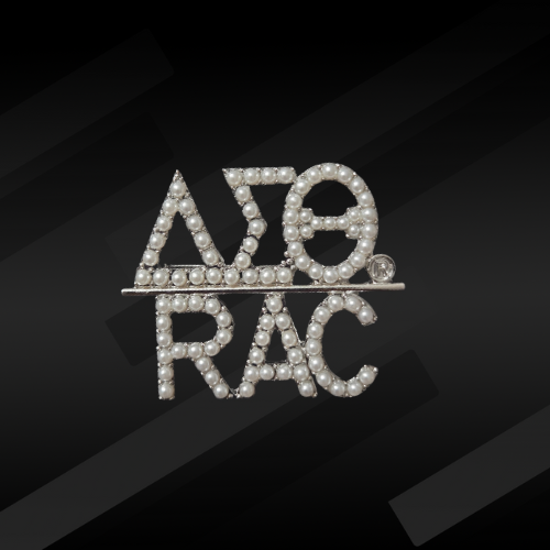 A pearl-encrusted pin featuring the DST Greek letters and the RAC symbol.