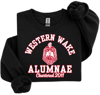 A collection of four sweatshirts in black, white, and red colors with the text 'Western Wake Alumnae' and a graphic emblem on the front.