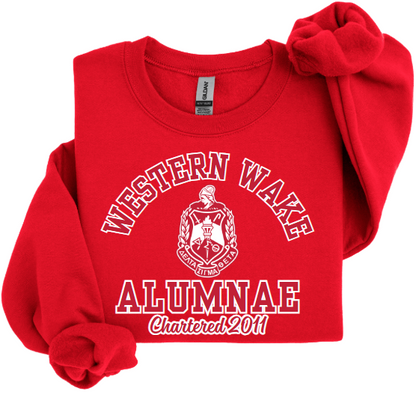 A collection of four sweatshirts in black, white, and red colors with the text 'Western Wake Alumnae' and a graphic emblem on the front.